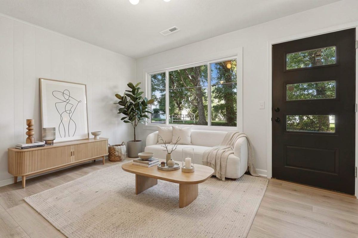Living room virtually staged with a white sofa and wood coffee table