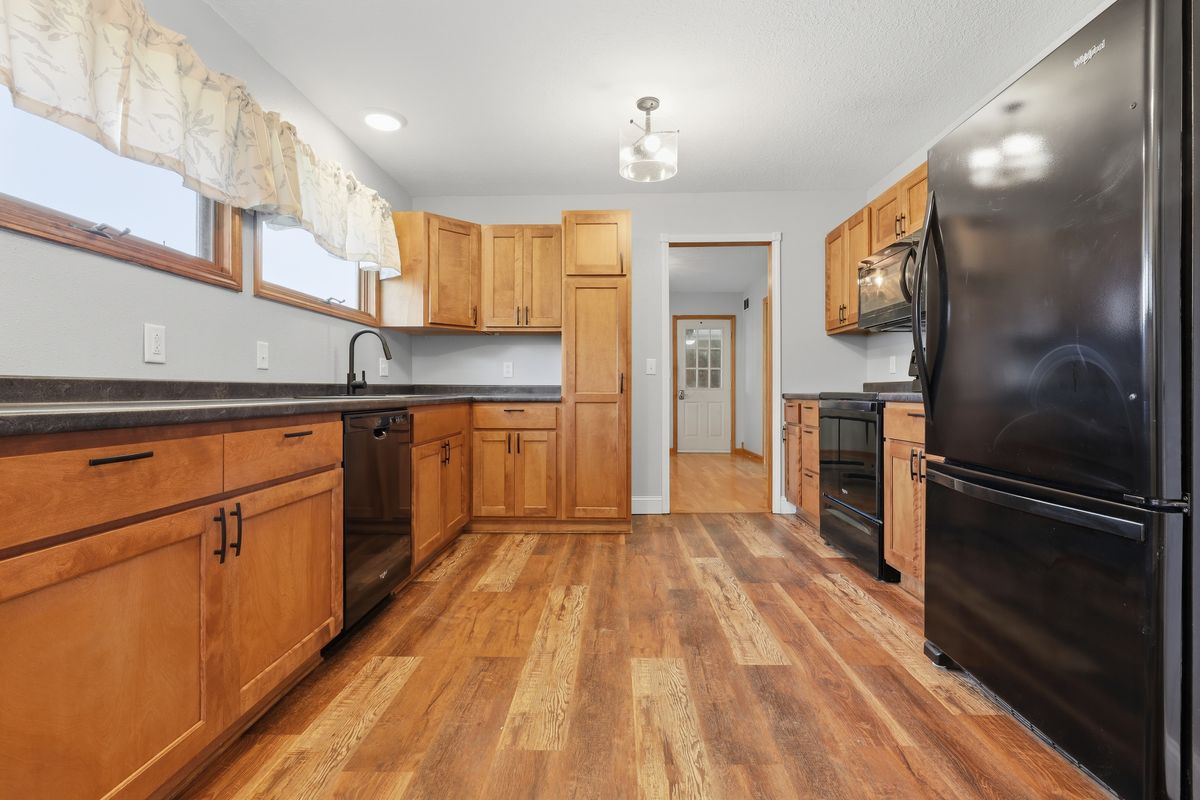 Kitchen with wood cabinets and black appliances